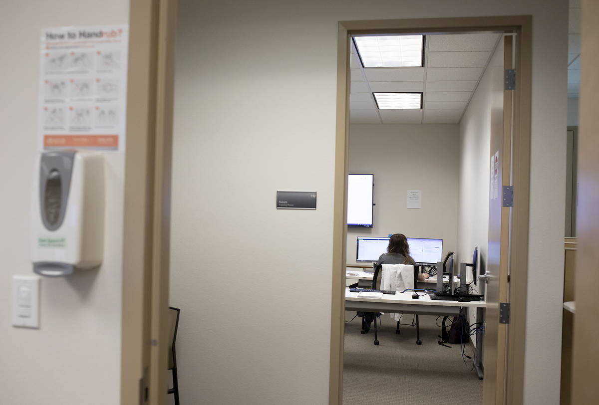 Danyelle Myers, a third-year OBGYN resident, answers calls at a COVID-19 call center at a UNLV ...