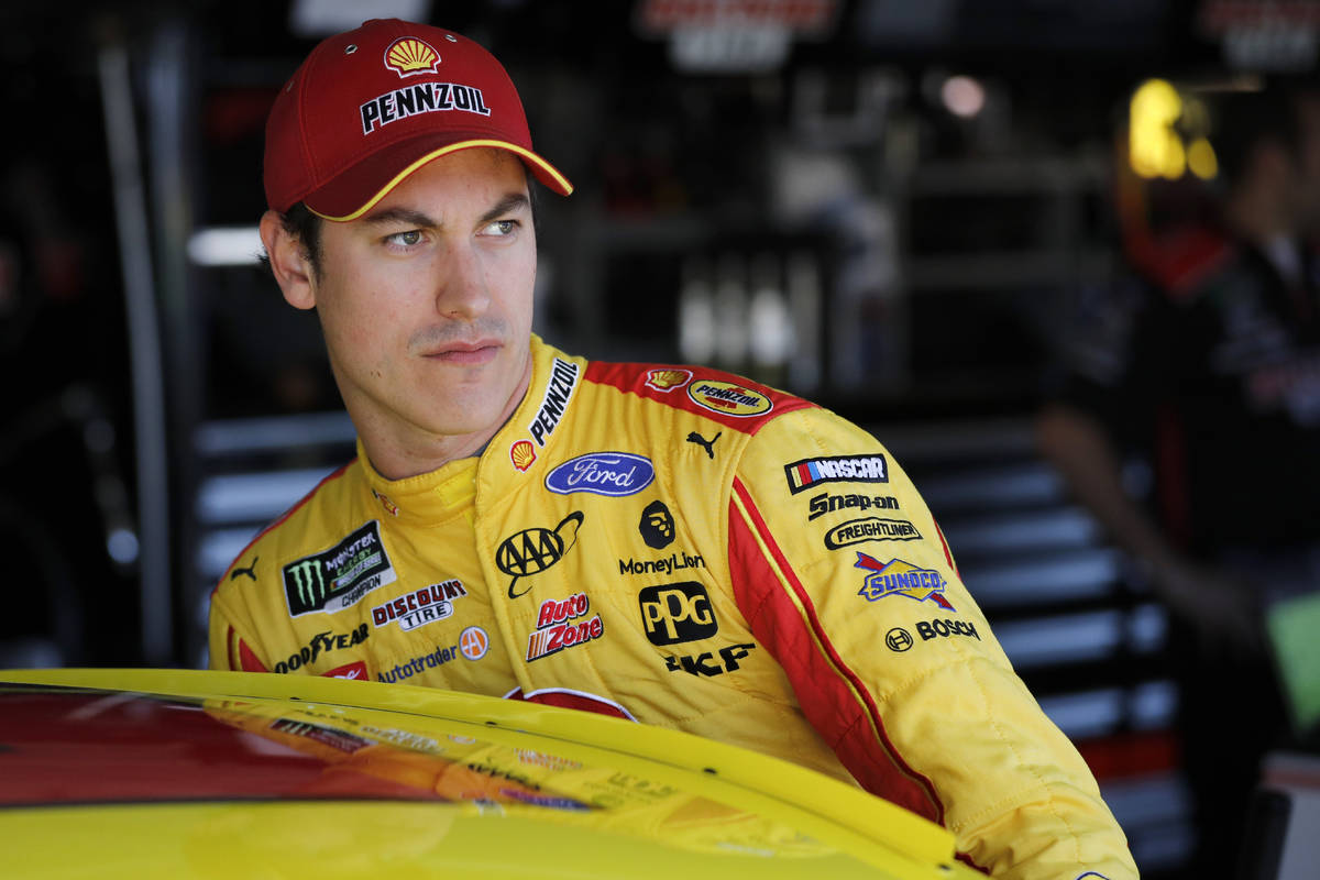 FILE - In this Oct. 18, 2019, file photo, NASCAR driver Joey Logano climbs into his car to prac ...