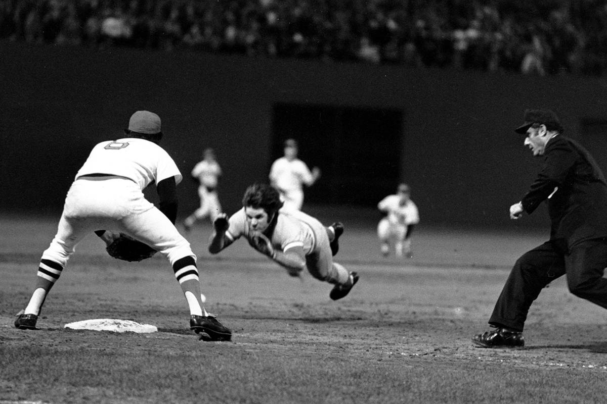 Pete Rose of the Cincinnati Reds is shown diving into third base in the ninth inning of Game 7 ...