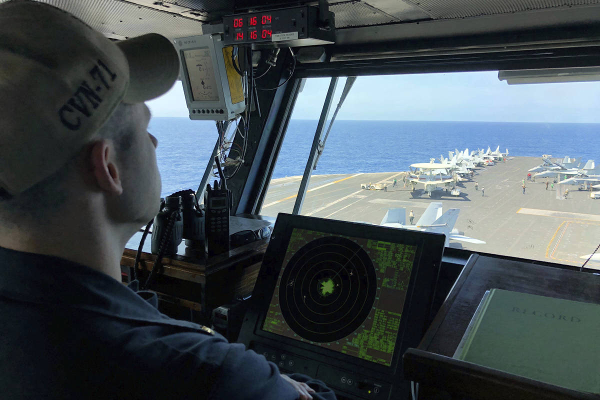 FILE - In this April 10, 2018, file photo, a U.S. Navy crewman monitors on the deck of the U.S. ...