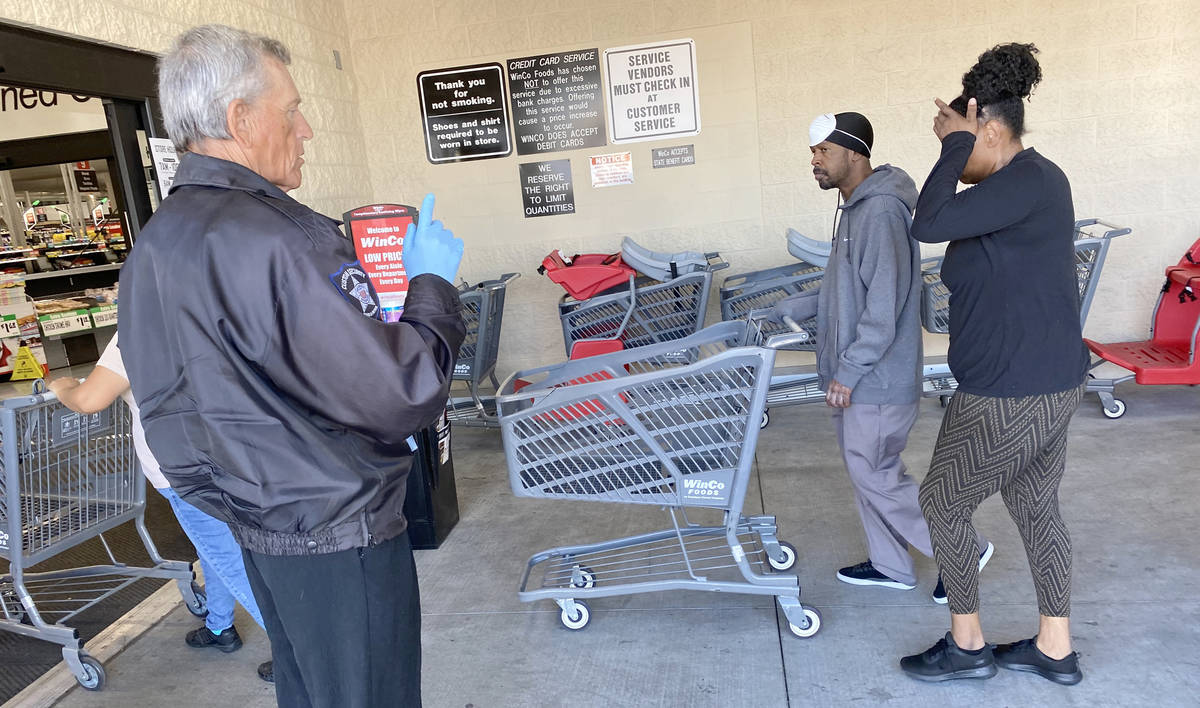 A security guard counts shoppers at WinCo Foods at 7501 Washington Ave. in Las Vegas Tuesday, M ...