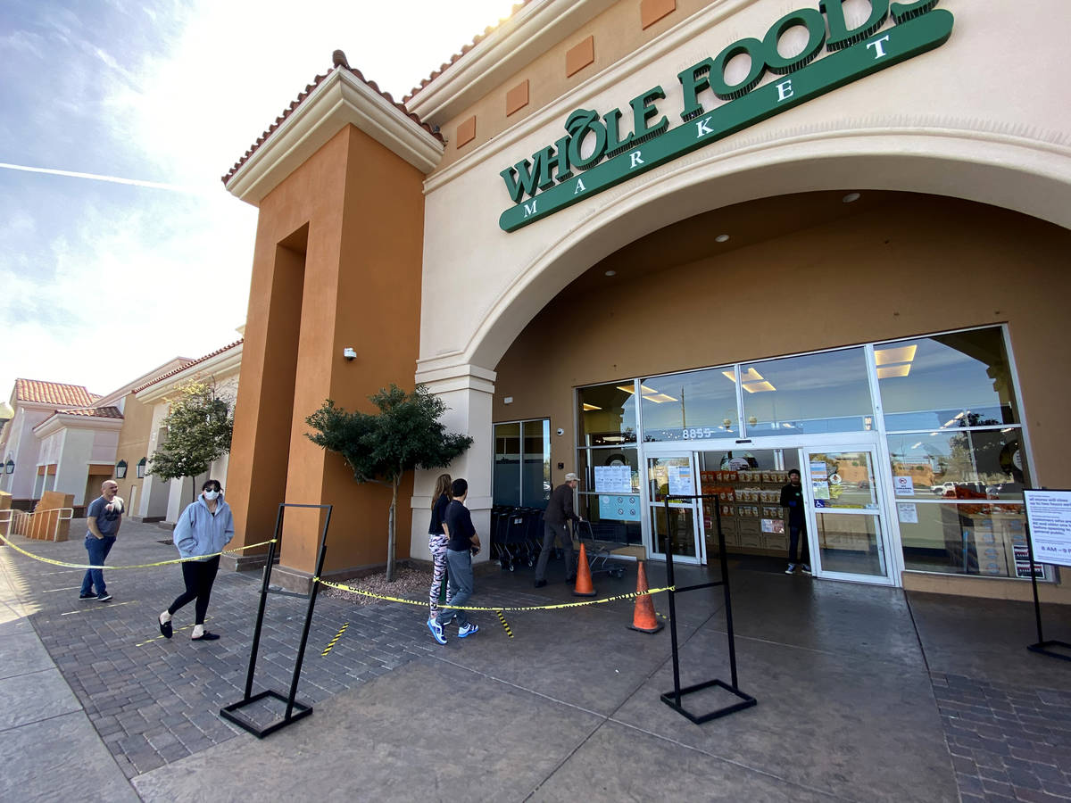 Shoppers queue up at six-foot distances at Whole Foods at 8855 W. Charleston Blvd. in Las Vegas ...