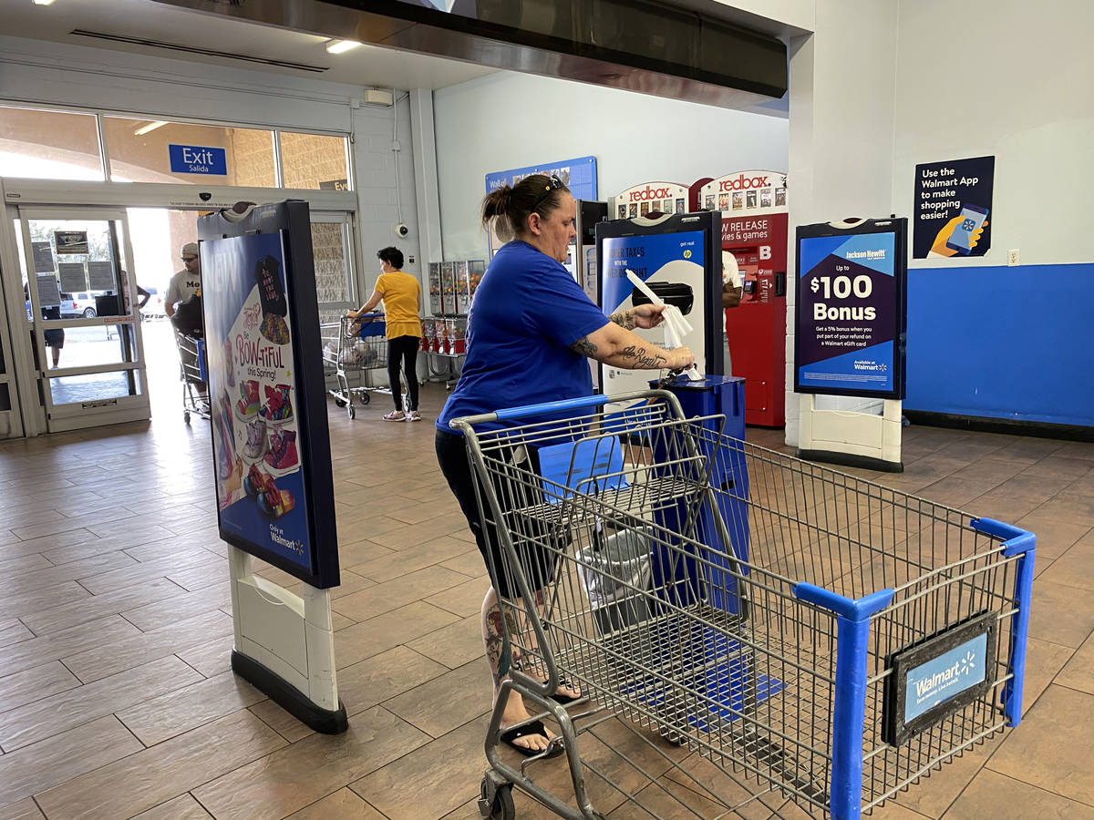 Customers grab sanitizing wipes at Walmart Supercenter at 3950 W. Lake Mead Blvd. in North Las ...