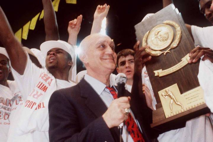 UNLV head basketball coach Jerry Tarkanian stands with his team after the Runnin Rebels won the ...