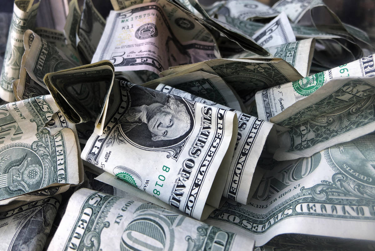FILE - This Wednesday, April 3, 2019, file photo shows a box filled with dollar bills, in New Y ...