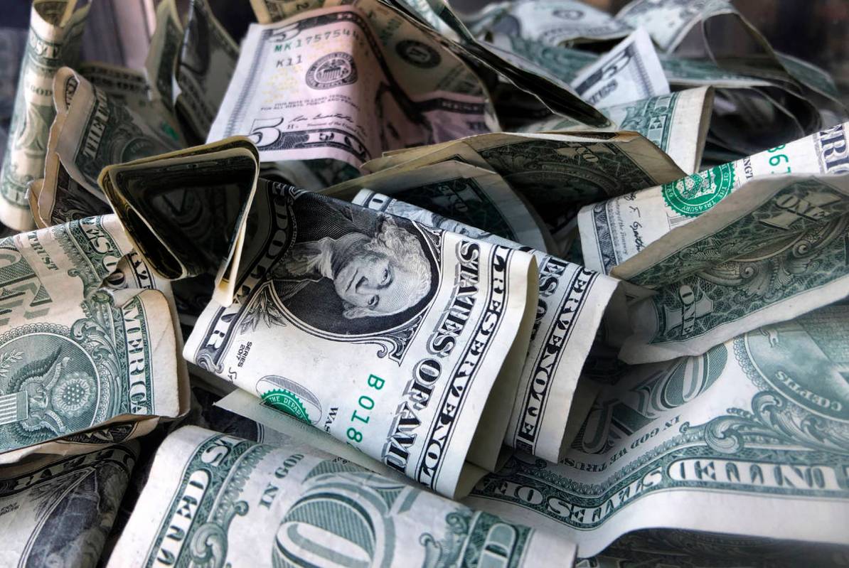 FILE - This Wednesday, April 3, 2019, file photo shows a box filled with dollar bills, in New Y ...