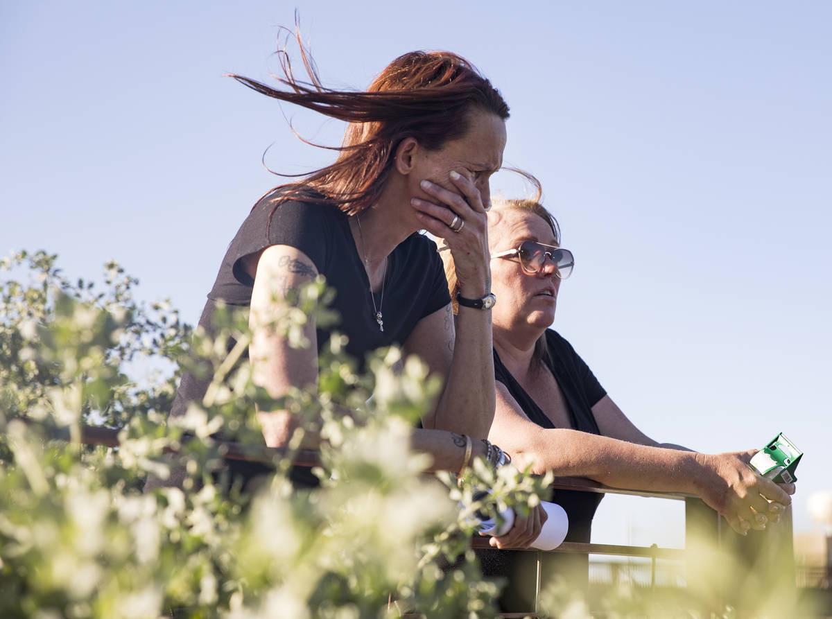 Wendy Cox, left, cries with her friend Lisa Hartwick, right, as she nears the end of her search ...