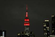 The Empire State building is lit in red and white lights to honor emergency medical workers Tue ...