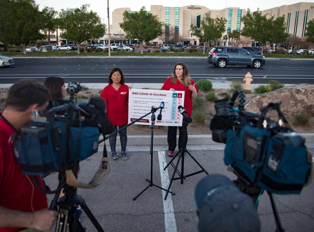 Dina Armstrong, a nurse and chief nurse for National Nurses Untied, left, addresses the media a ...