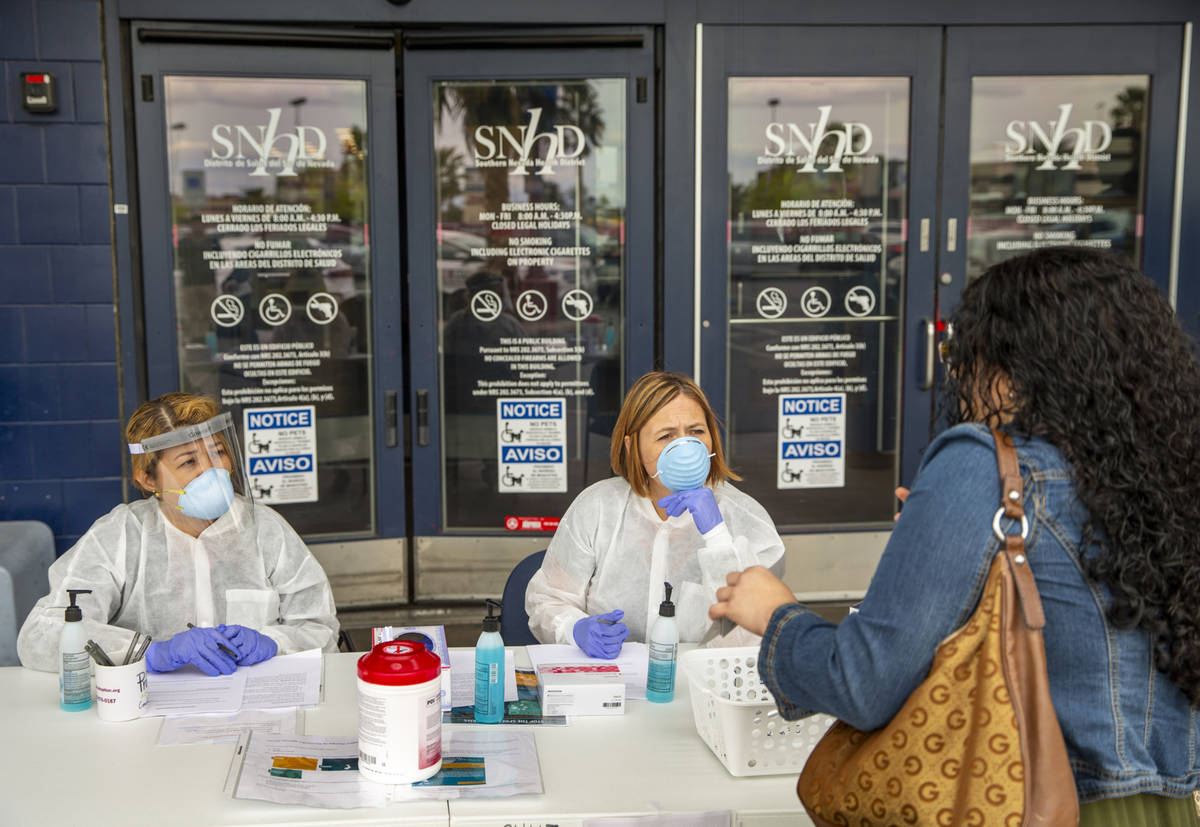 Southern Nevada Health District Registered nurse Joanna Corpuz, left, and immunization clinic a ...