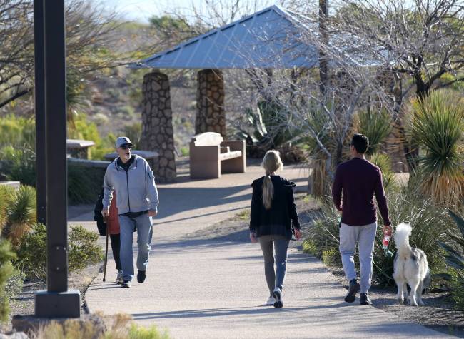 People exercise at Hualapai Canyon hiking area in Las Vegas Wednesday, April 1, 2020. (K.M. Can ...
