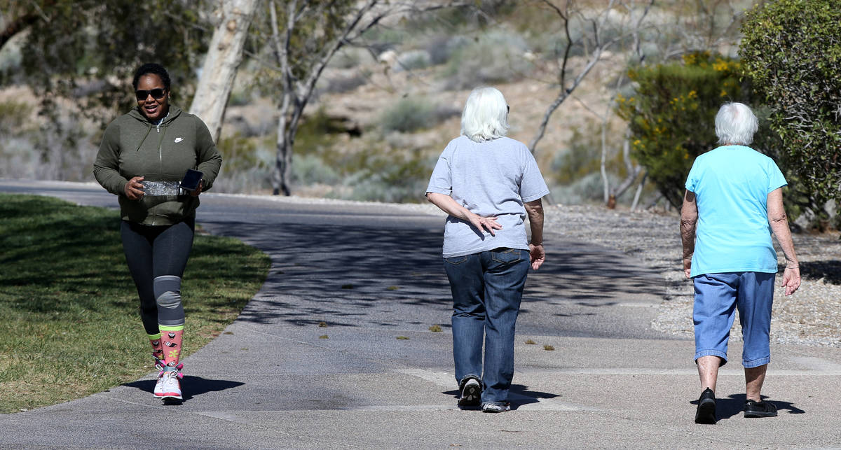 Mary Scharn, 84, right and Barbara Cots, 70, pass Alexis Jones, 31, while exercising at Pueblo ...