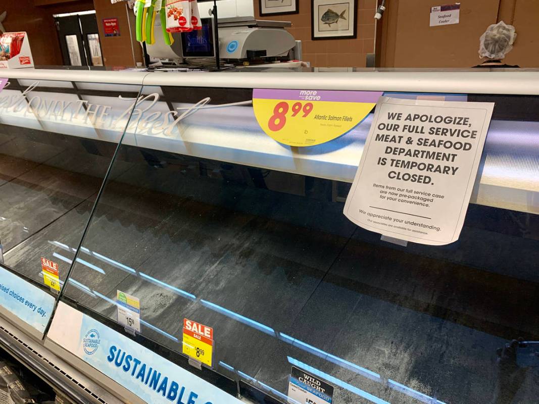 A sign stating the temporary closure of the meat and seafood department at the Smith's store on ...
