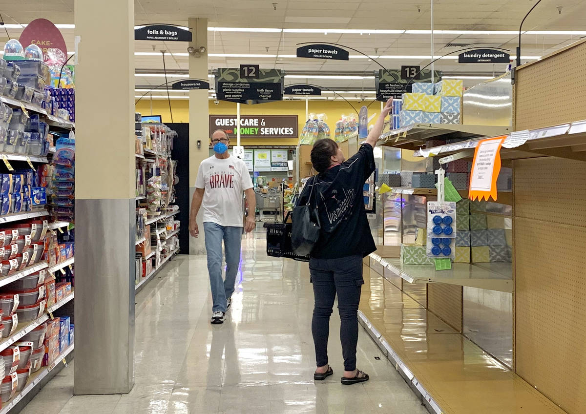 The bath tissue isle is nearly empty as shoppers pass through at the Smith's store on E Sunset ...