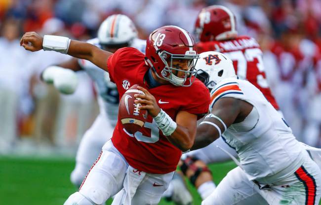 FILE - In this Saturday, Nov. 24, 2018, file photo, Alabama quarterback Tua Tagovailoa (13) esc ...