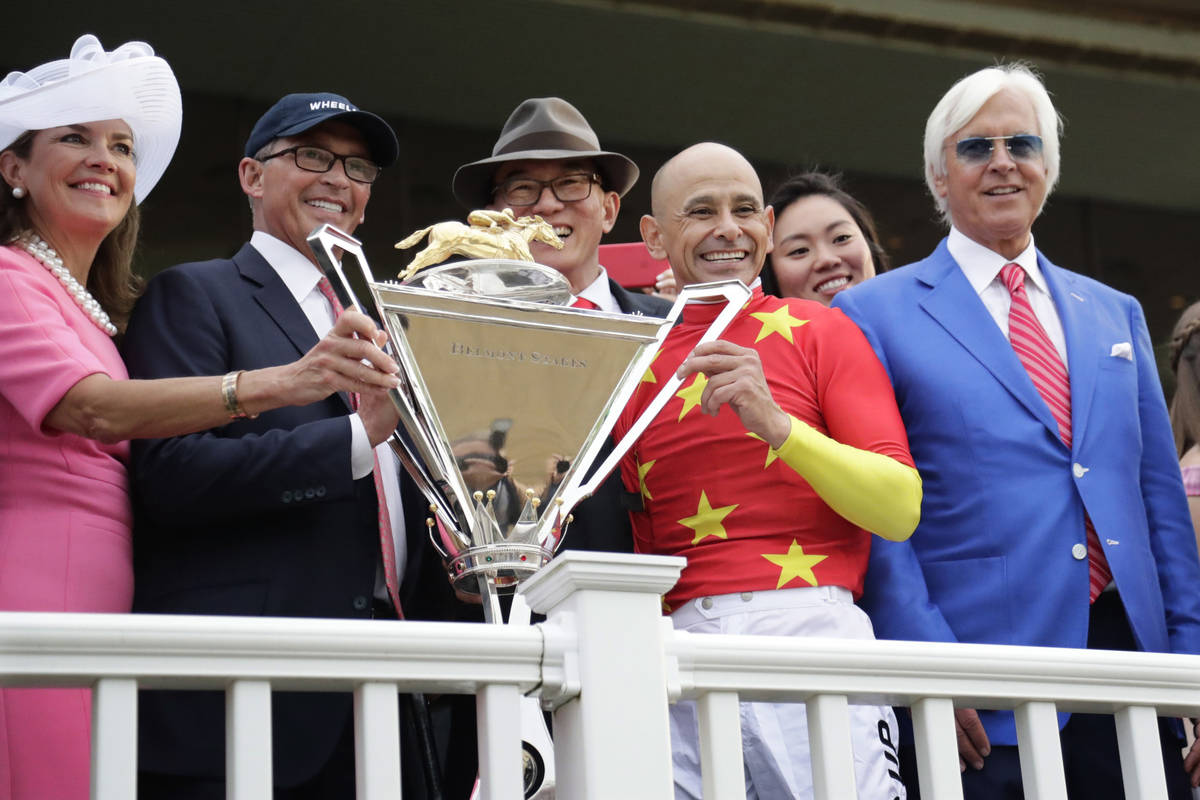 Jockey Mike Smith, second from right, trainer Bob Baffert, right, and owners Kenny Trout, secon ...