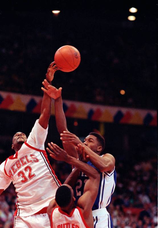 UNLV forward Stacey Augmon, left, goes up to block Duke forward Robert Brickey's shot during th ...