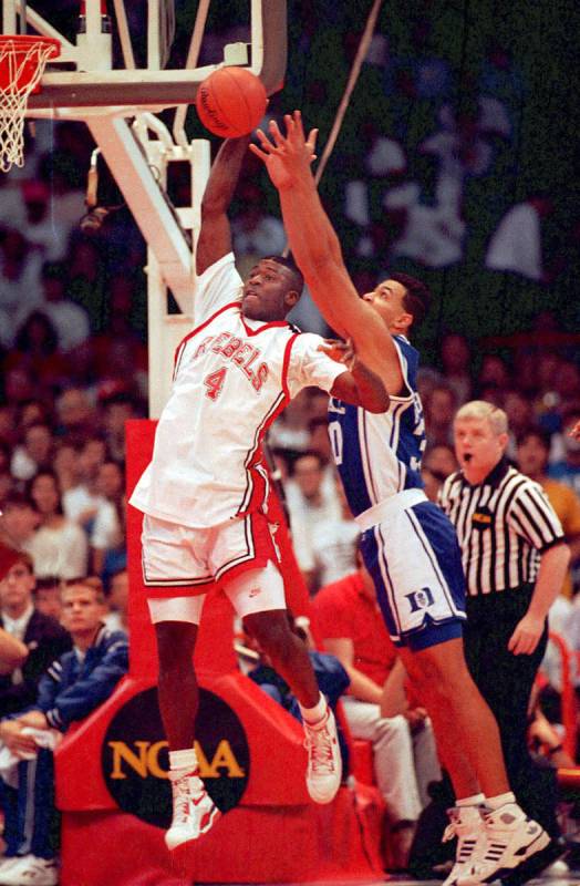 UNLV basketball forward Larry Johnson gets off shot beyond the defensive reach of Duke's Alaa A ...