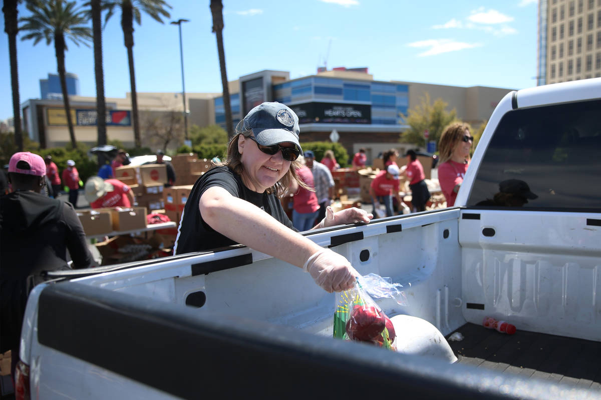 Three Square Food Bank volunteer Heather Nelson gives out food at Palace Station Casino in Las ...