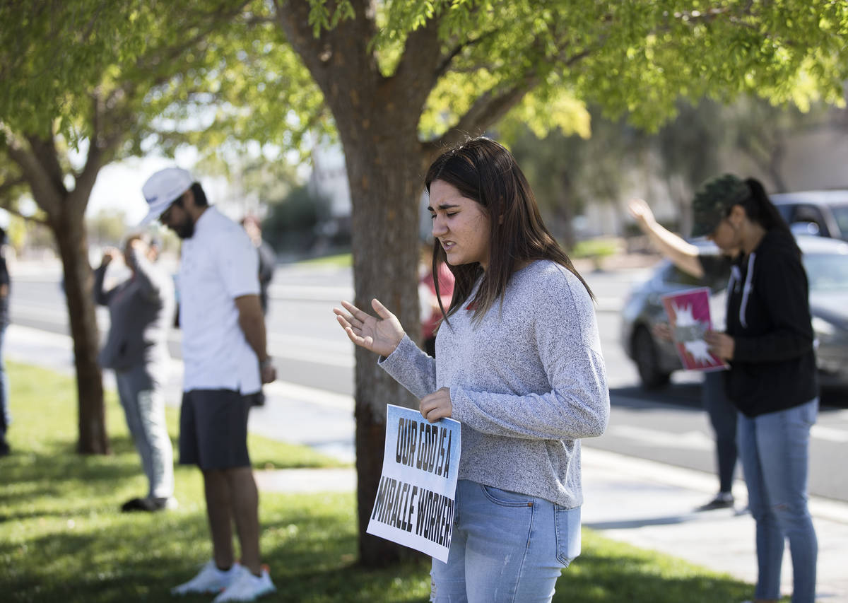 Dariahne Navarro, 16, center, prays with family and friends for her cousin Adriana Huh who is i ...