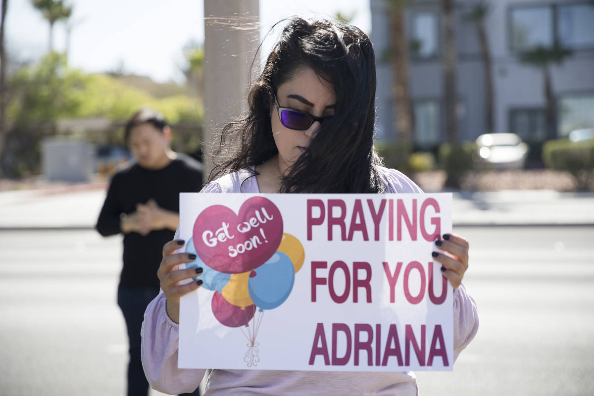 Stephanie Romero prays with family and friends for her cousin Adriana Huh who is in the hospita ...