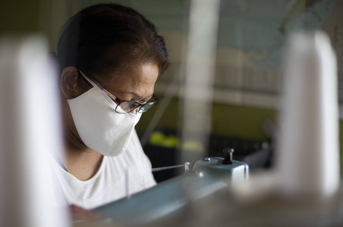 Alia Berry sews masks, meant to protect people from COVID-19, at her home on Friday, April 3, 2 ...