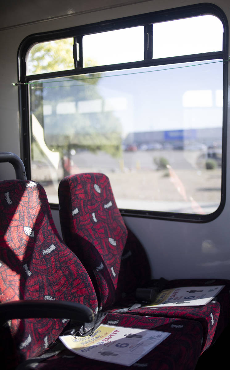 A sign reserves seats to maintain social distancing and COVID-19 safety while the bus pulls int ...