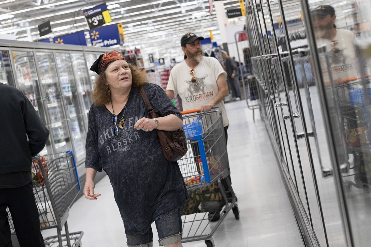 Debbie Holmgren and Todd Henke shop for food in the frozen section of Walmart on Saturday, Apri ...