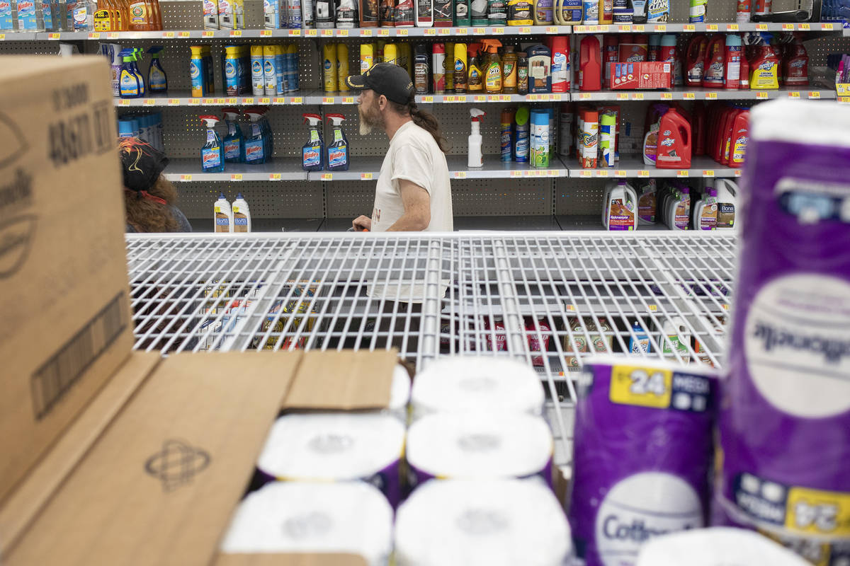 Todd Henke walks through the cleaning products aisle as just a few rolls of toilet paper are le ...