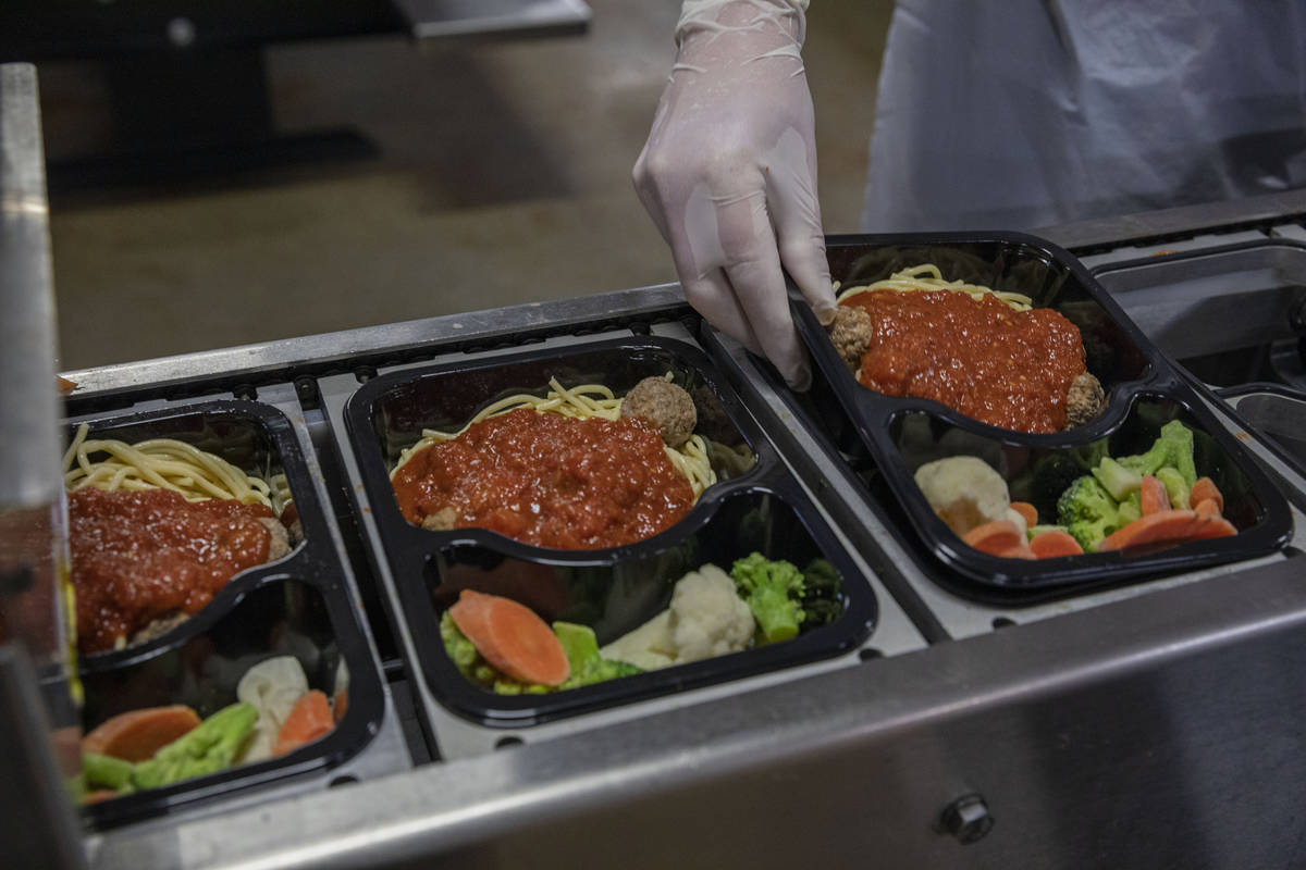 Meals on Wheels spaghetti and meatball dishes are packaged at Catholic Charities of Southern Ne ...