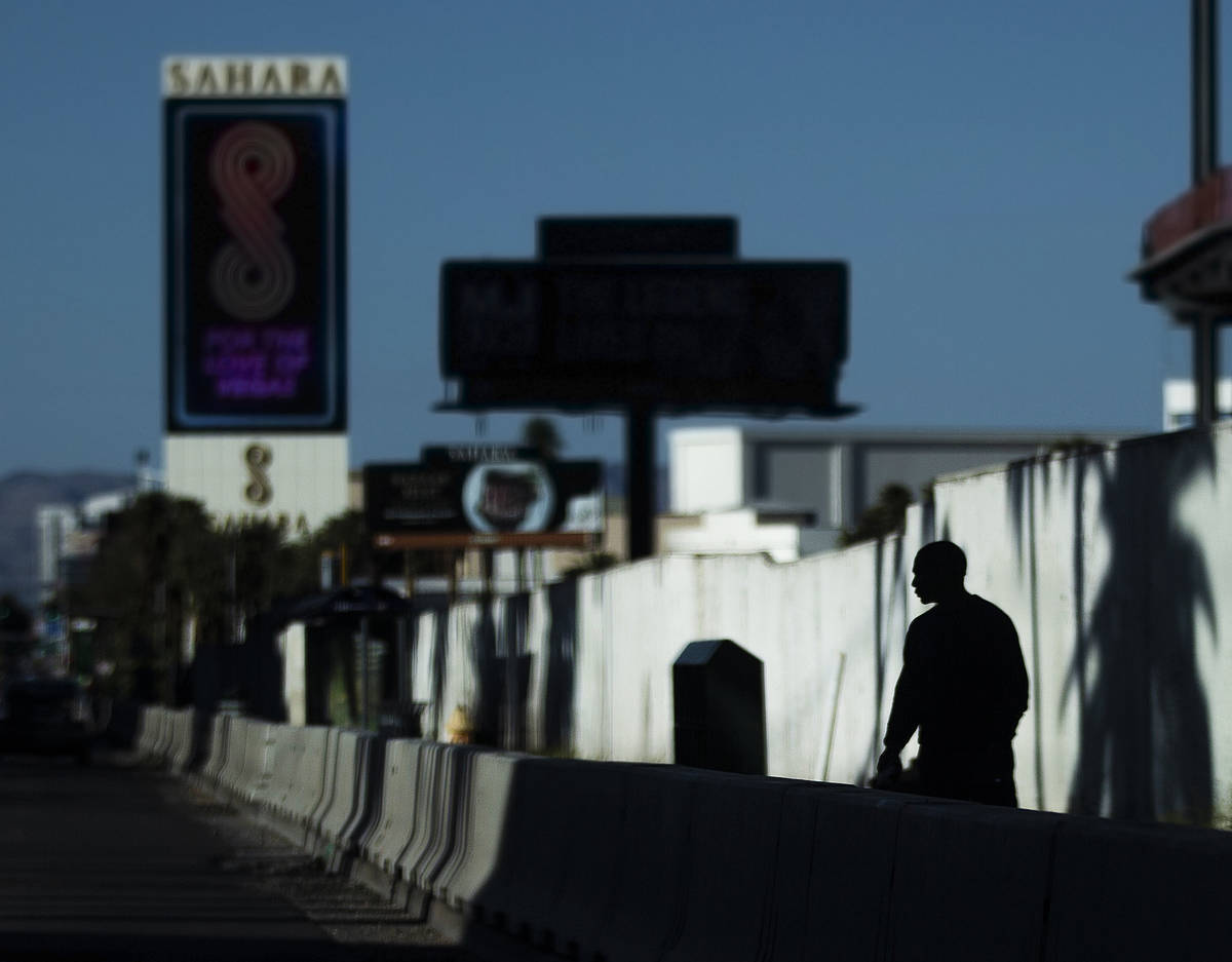 A single pedestrian walks on the Strip on Saturday, April 4, 2020, in Las Vegas. (Benjamin Hage ...
