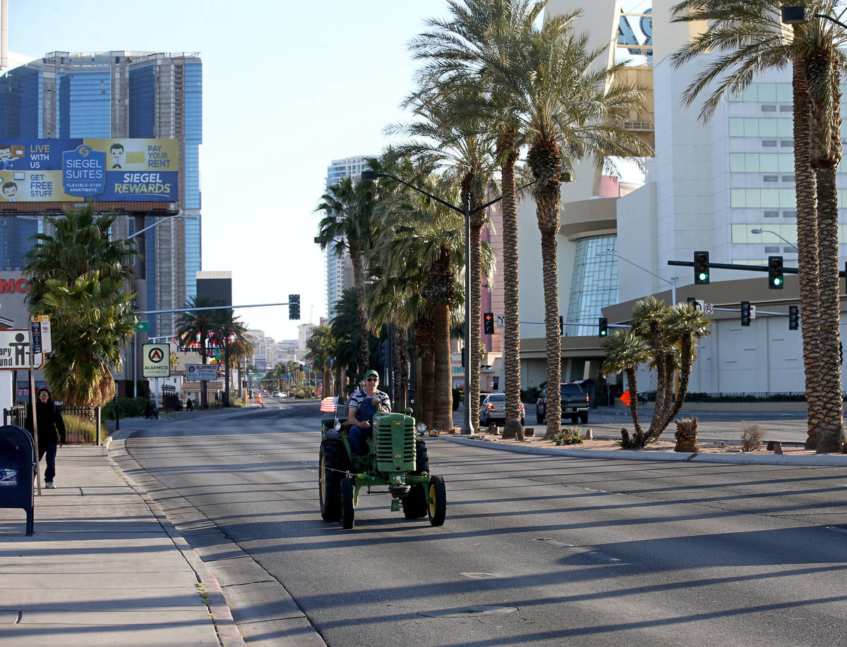 Kristin Grange, 58, drives his 1949 John Deere tractor on Las Vegas Boulevard near St. Louis Av ...