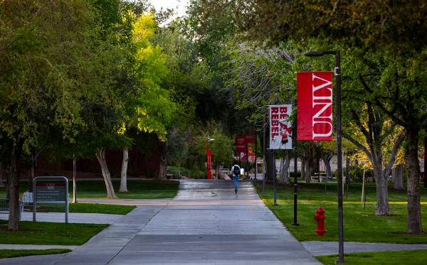 A man rides a scooter around UNLV as activity remains light in the wake of the closure of a sta ...