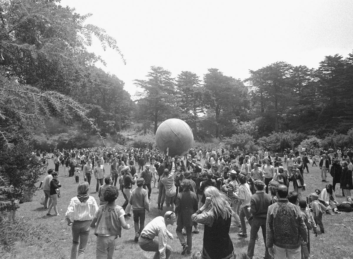 FILE - In this June 21, 1967, file photo, people keep a large ball, painted to represent a worl ...
