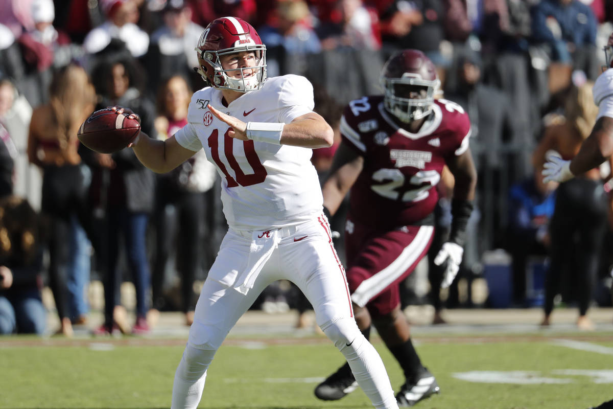 Alabama quarterback Mac Jones (10) rears back to pass downfield as Mississippi State defensive ...