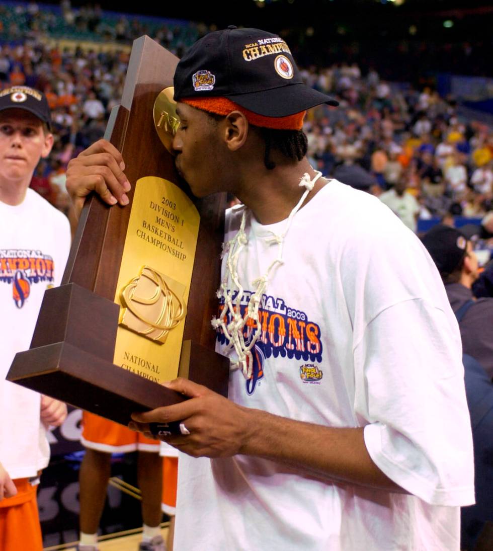FILE - In this April 7, 2003, file photo, Syracuse's Carmelo Anthony kisses the trophy after wi ...