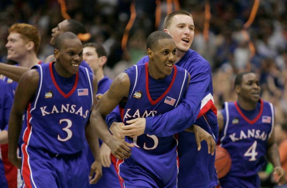 FILE - In this April 7, 2008, file photo, Kansas players Russell Robinson (3), Mario Chalmers ( ...