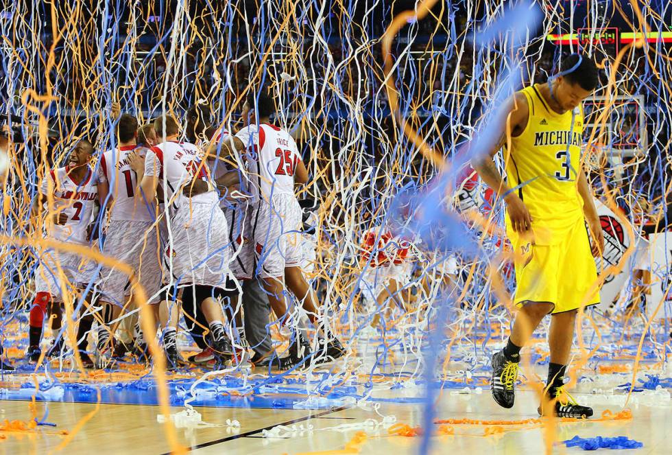 FILE - In this April 8, 2013, file photo, Michigan guard Trey Burke (3) walks off the court as ...
