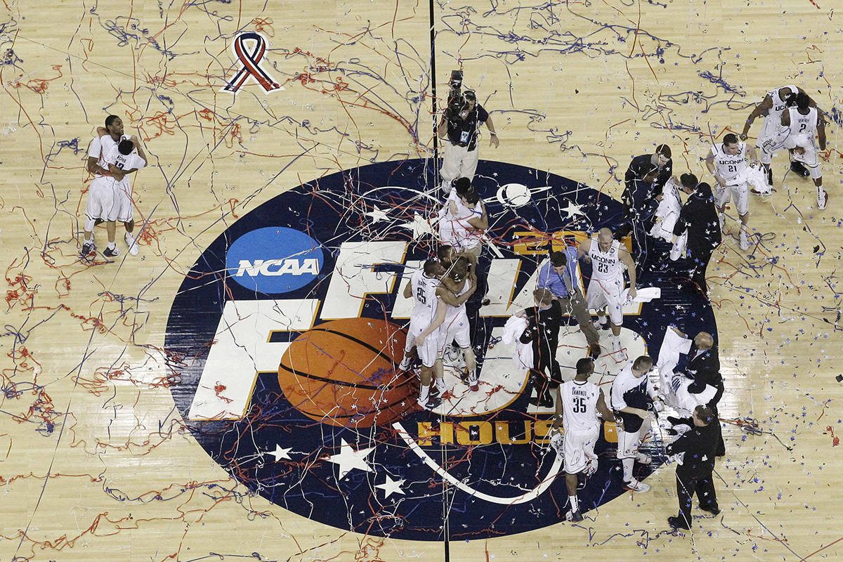 Connecticut celebrates after winning the men's NCAA Final Four college basketball championship ...
