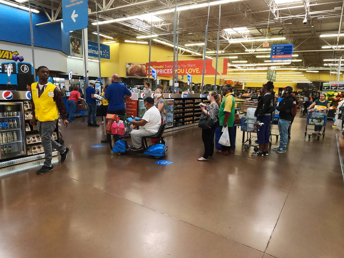 People line up to pay at the Walmart Supercenter, 3950 W Lake Mead Boulevard in North Las Vegas ...