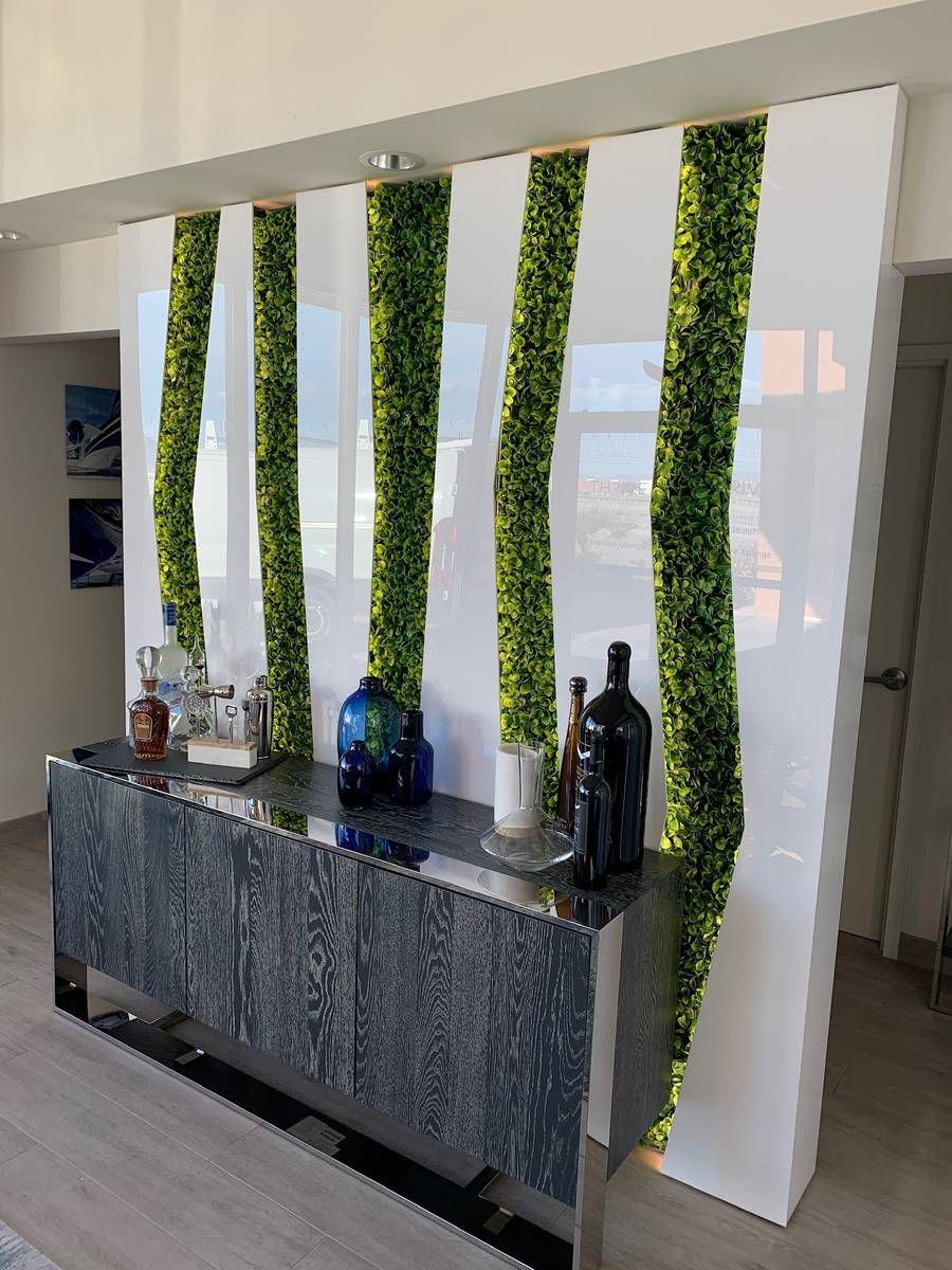 The wall for Thrive Aviation’s hangar lounge features a semi-transparent panel with back ligh ...
