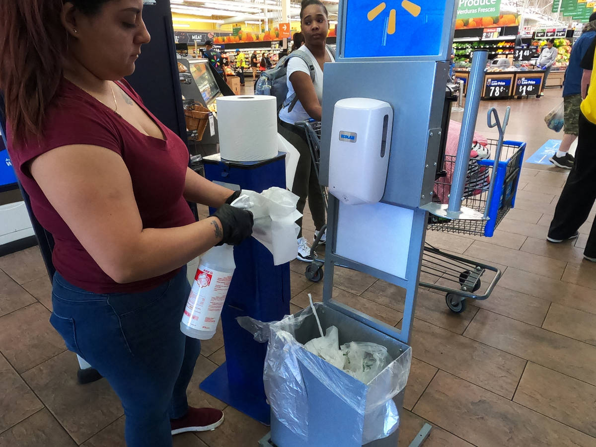 Sanitizing supplies are using by shoppers entering the Walmart Supercenter, 3950 W Lake Mead Bo ...