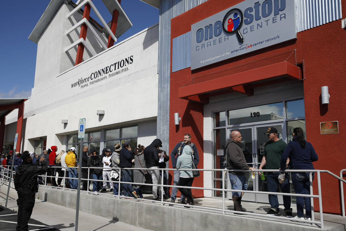 People wait in line for help with unemployment benefits at the One-Stop Career Center in Las Ve ...