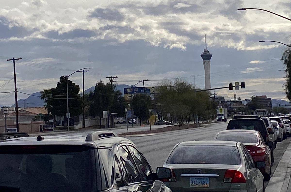 A line of cars estimated at several miles long line West Sahara Avenue as occupants wait for fo ...