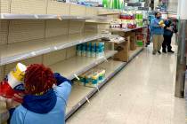 A Walgreens employee restocks toilet paper at the Las Vegas and Charleston boulevards location ...