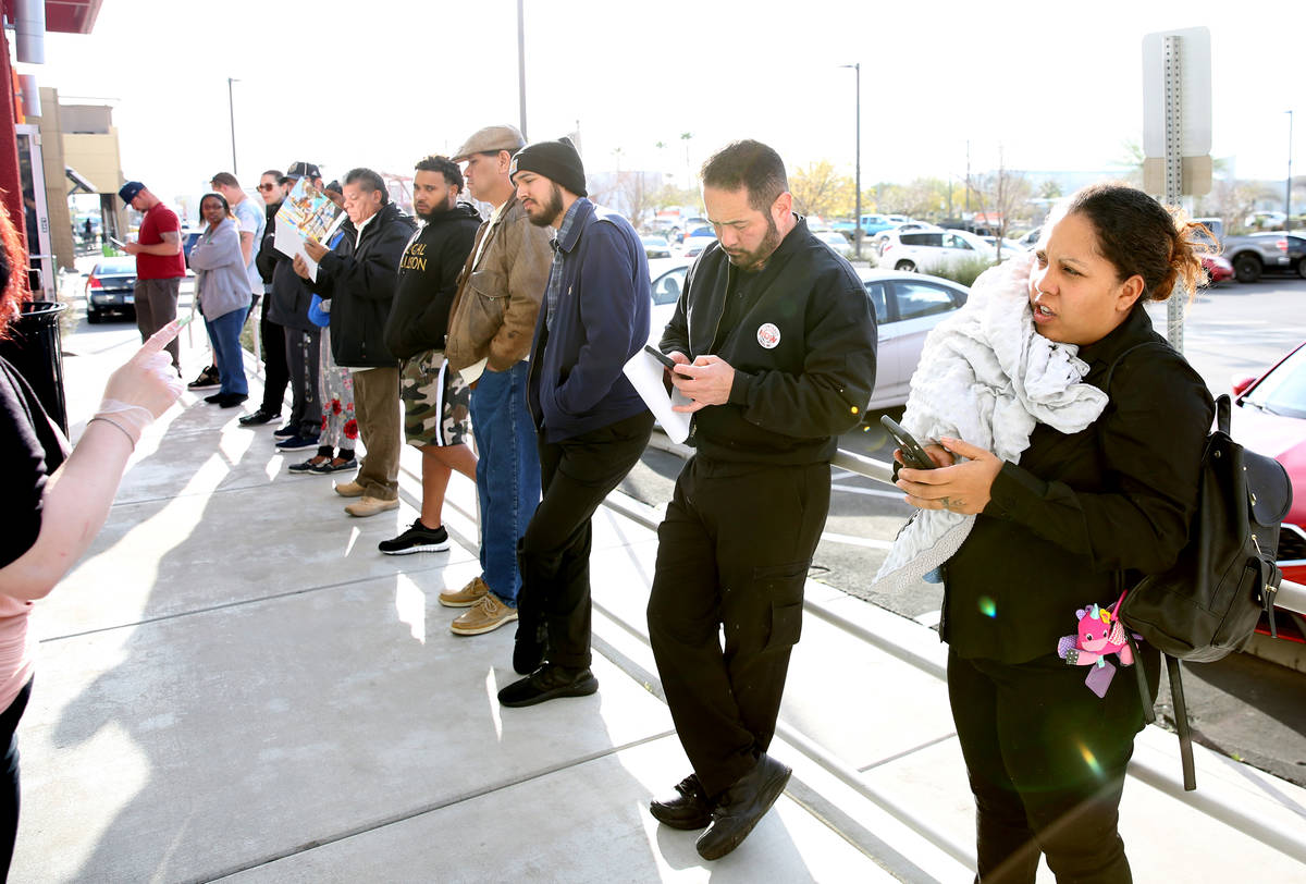 People wait in line at One-Stop Career Center, March 16, 2020, in Las Vegas. (Bizuayehu Tesfaye ...