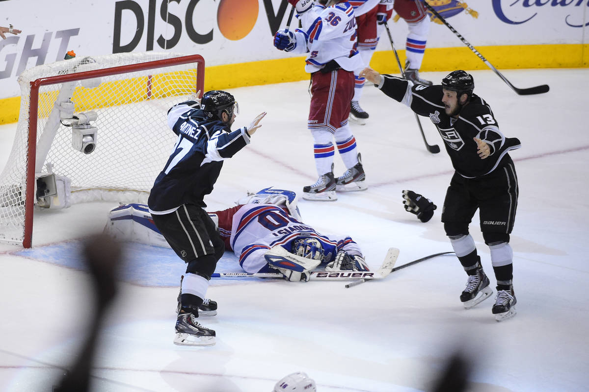 Los Angeles Kings defenseman Alec Martinez, left, and teammate left wing Kyle Clifford celebrat ...