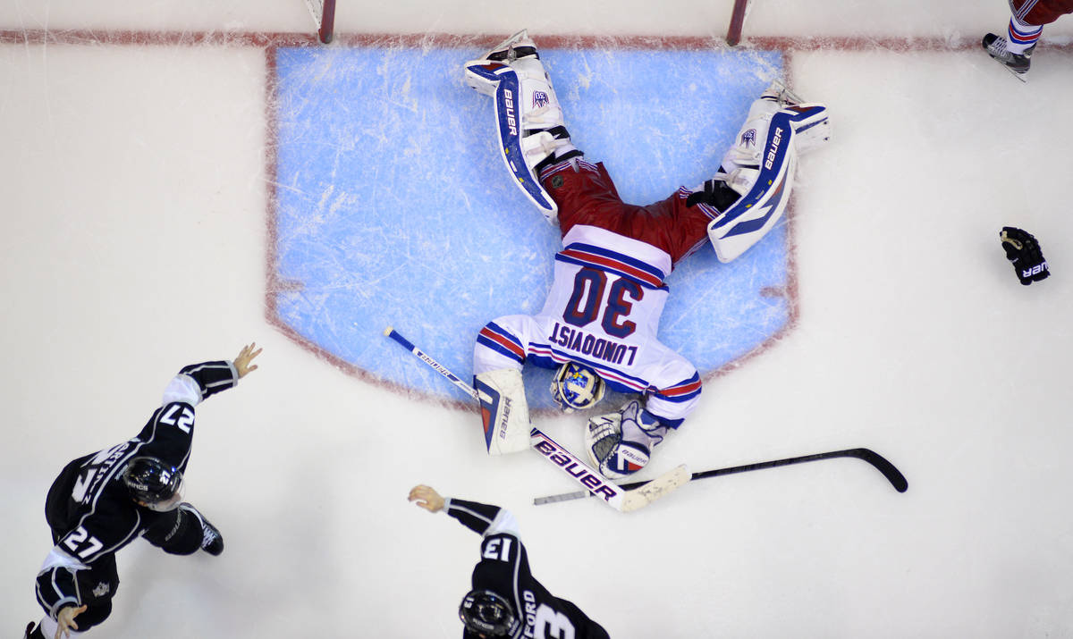 Los Angeles Kings defenseman Alec Martinez, lower left, celebrates with Kyle Clifford, lower ri ...