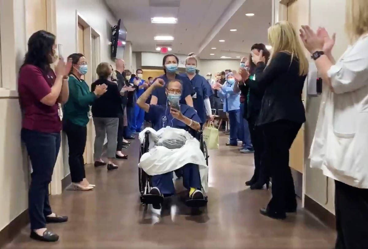 Southern Hills Hospital and Medical Center staff cheer as Alfred (no last name given) is discha ...