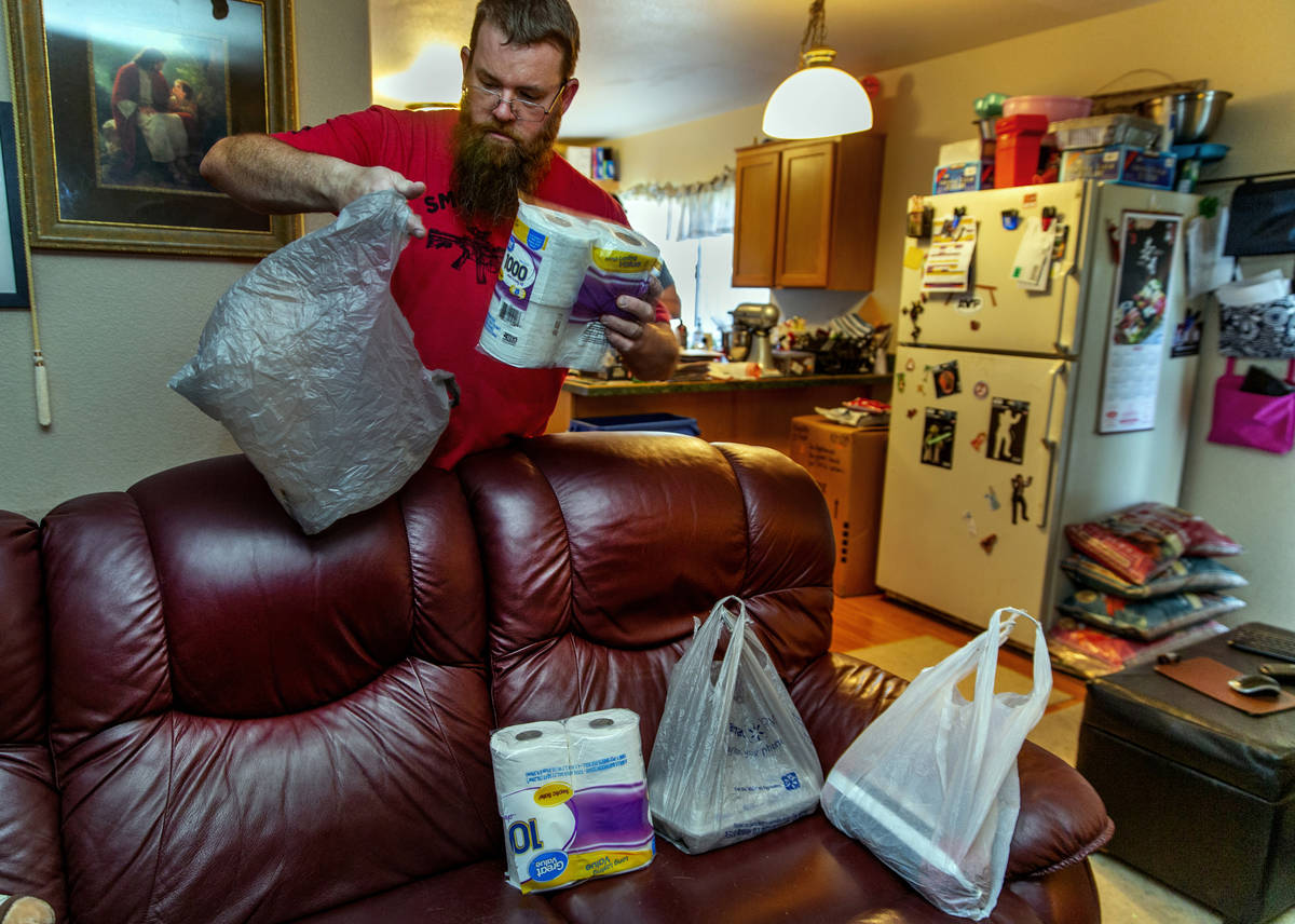 Marty Coon separates items for his wife Veronica who prepares for another donation drop with th ...